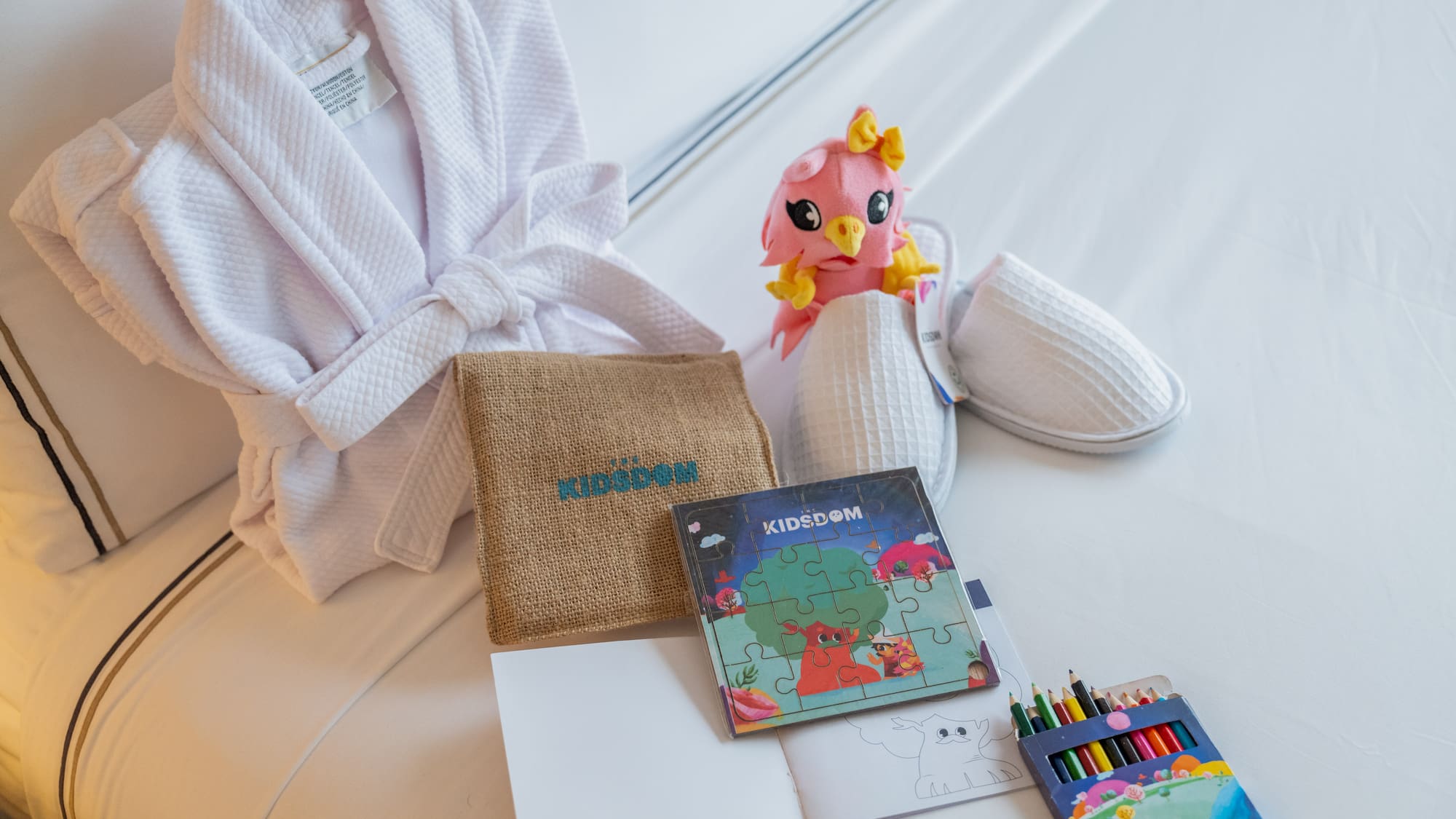 a white robe and a book and a stuffed animal