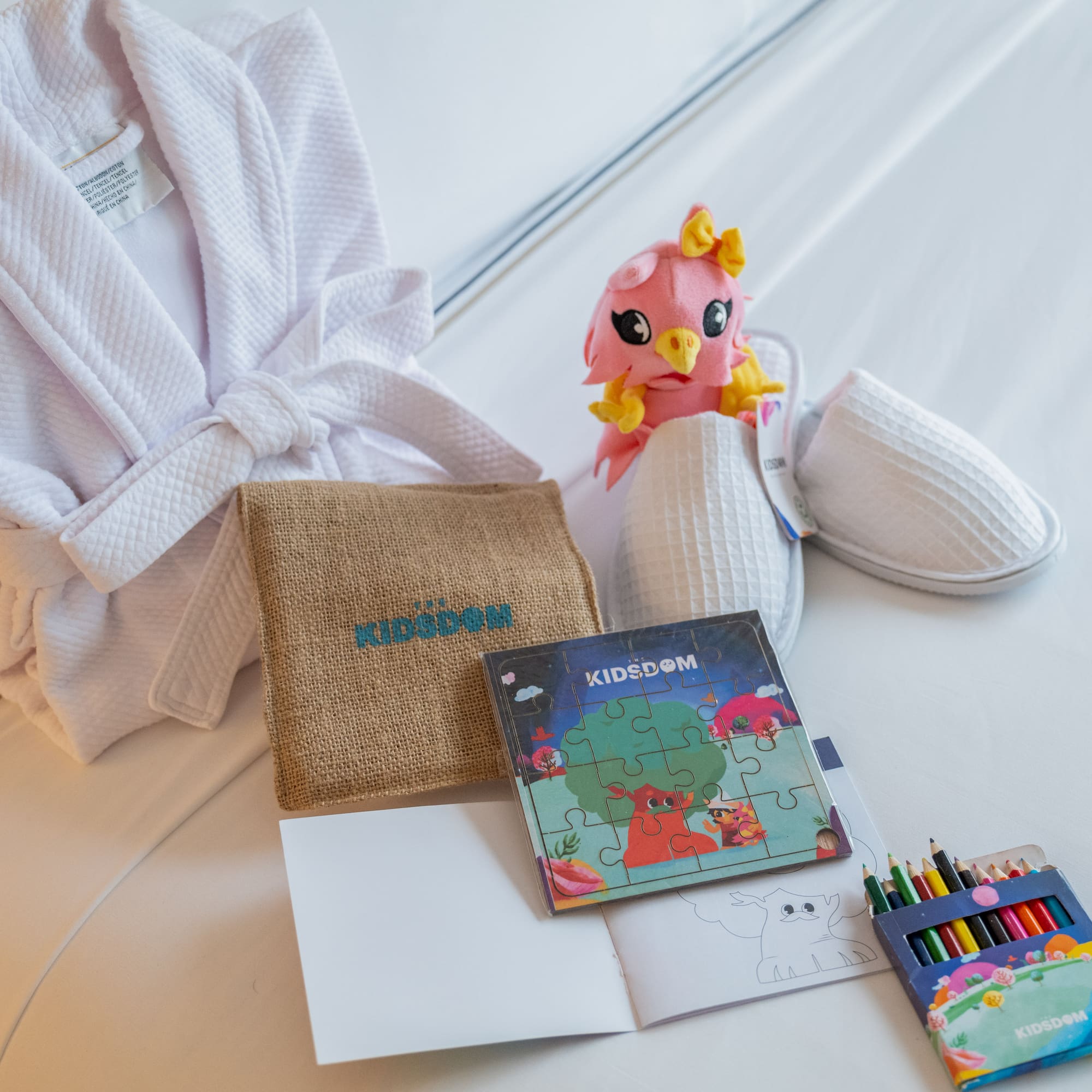 a white robe and a book and a stuffed animal
