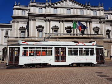 a white trolley in front of a building