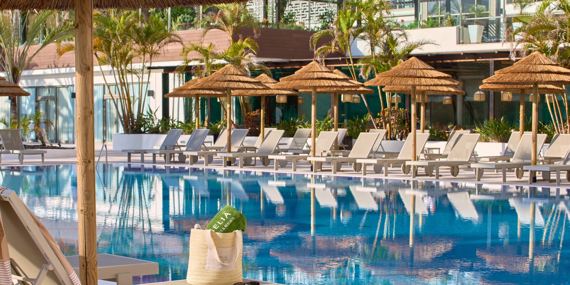 a pool with umbrellas and chairs
