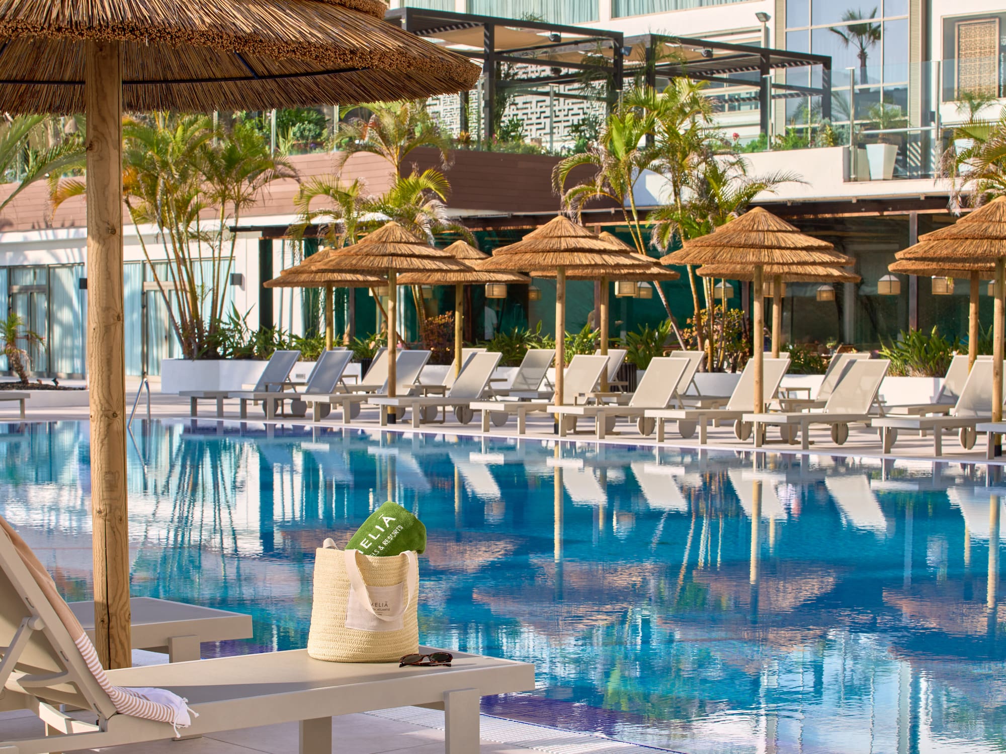 a pool with umbrellas and chairs