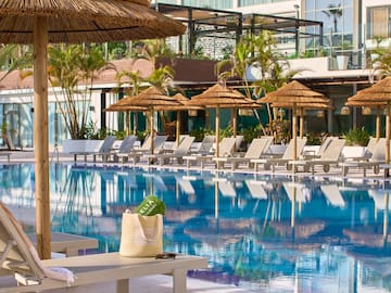 a pool with umbrellas and chairs