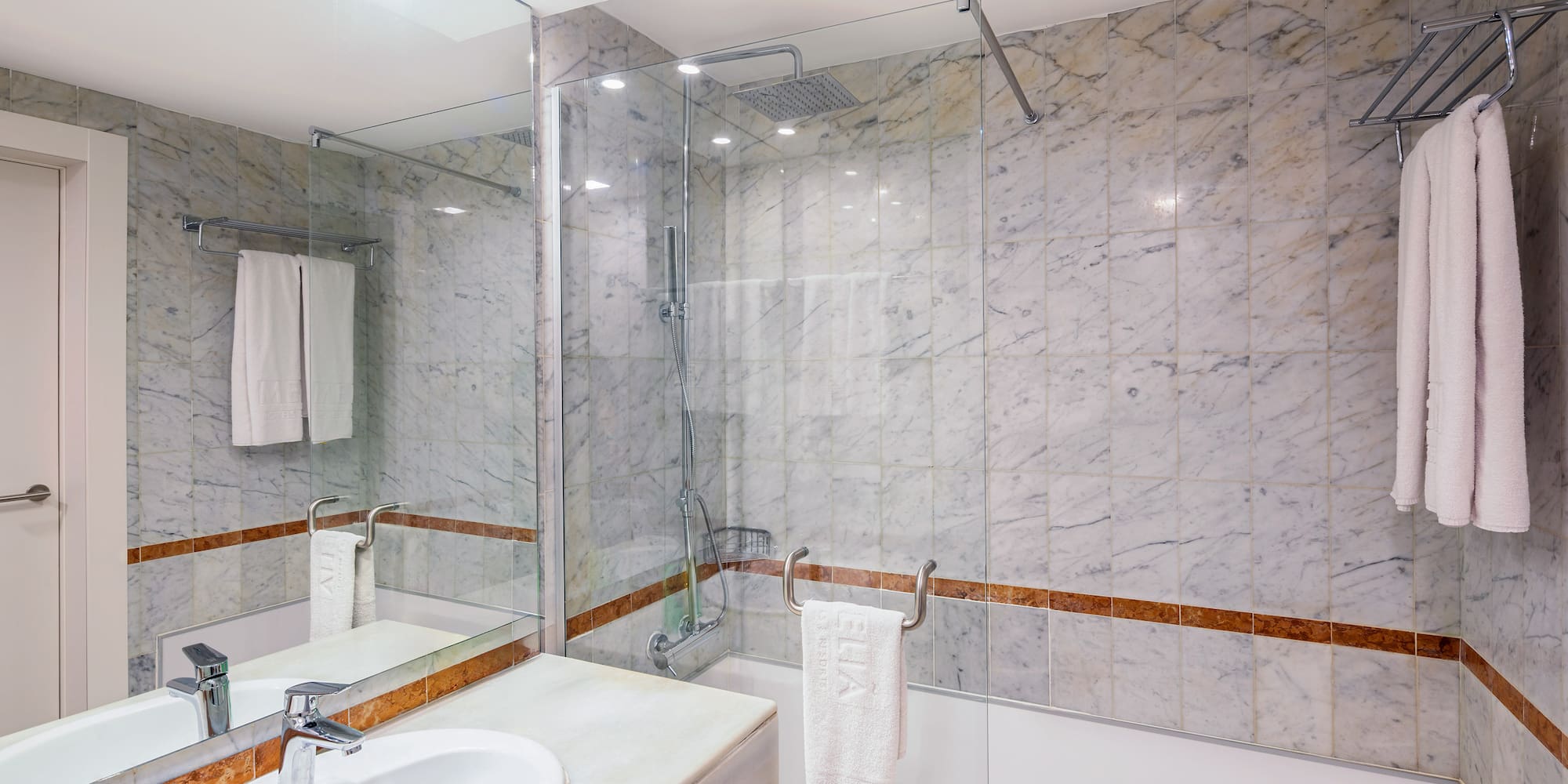 a bathroom with marble walls and a sink