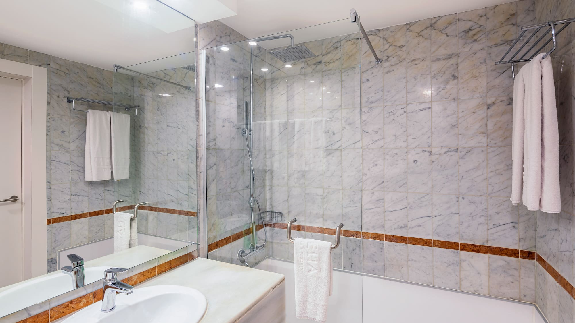 a bathroom with marble walls and a sink