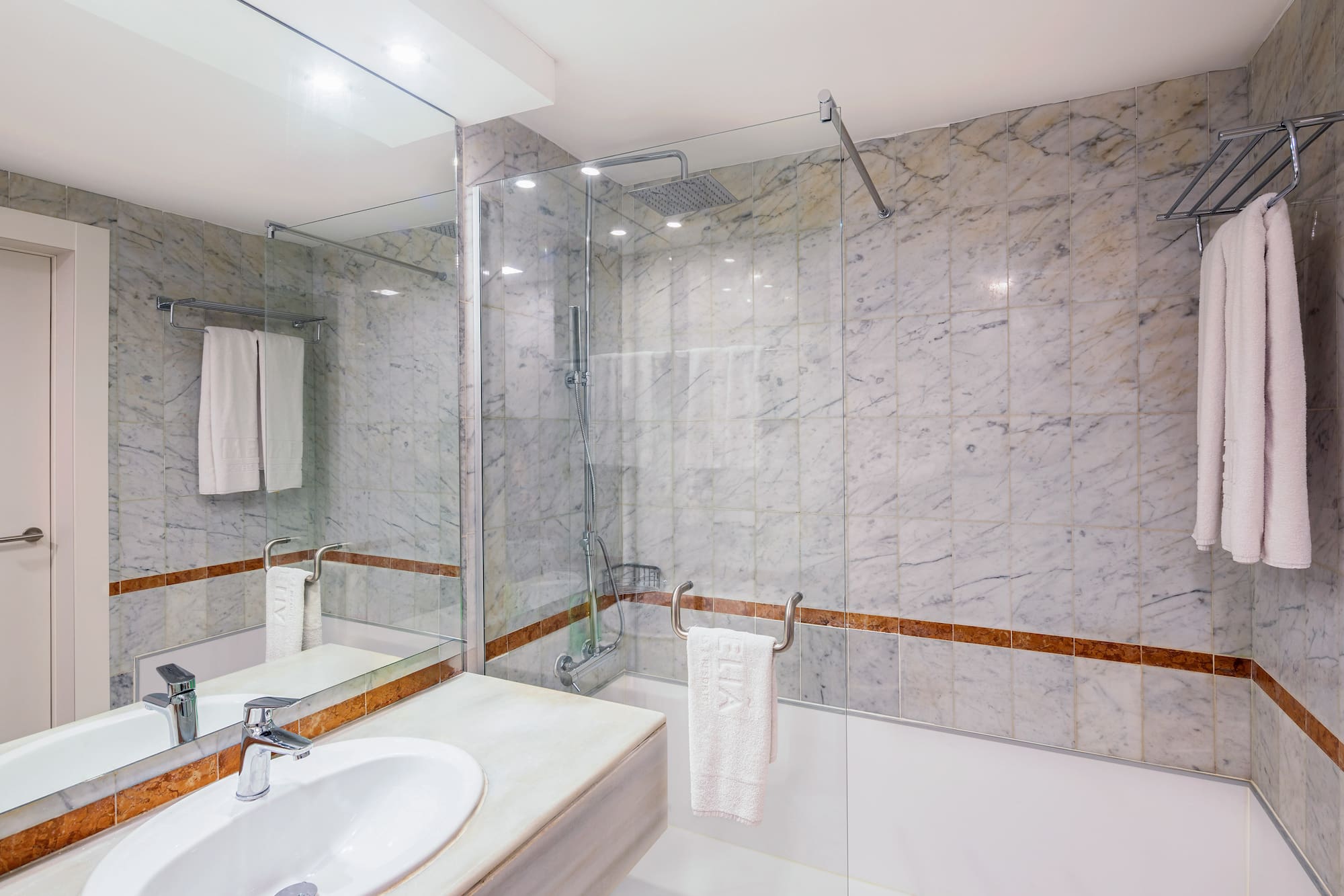 a bathroom with marble walls and a sink