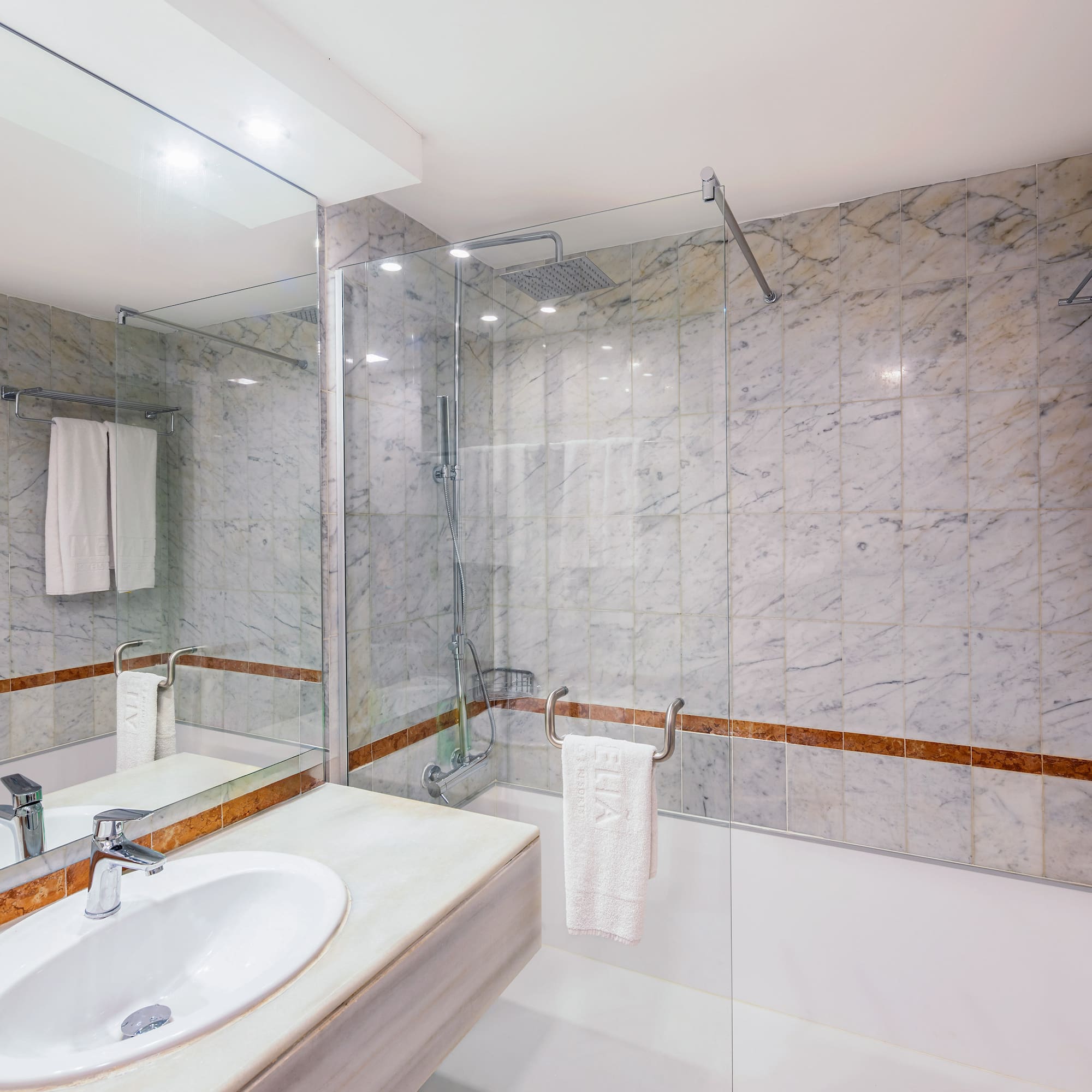 a bathroom with marble walls and a sink