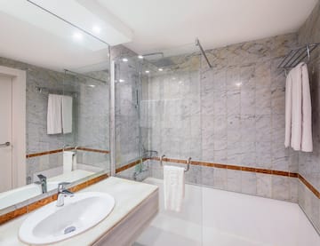 a bathroom with marble walls and a sink