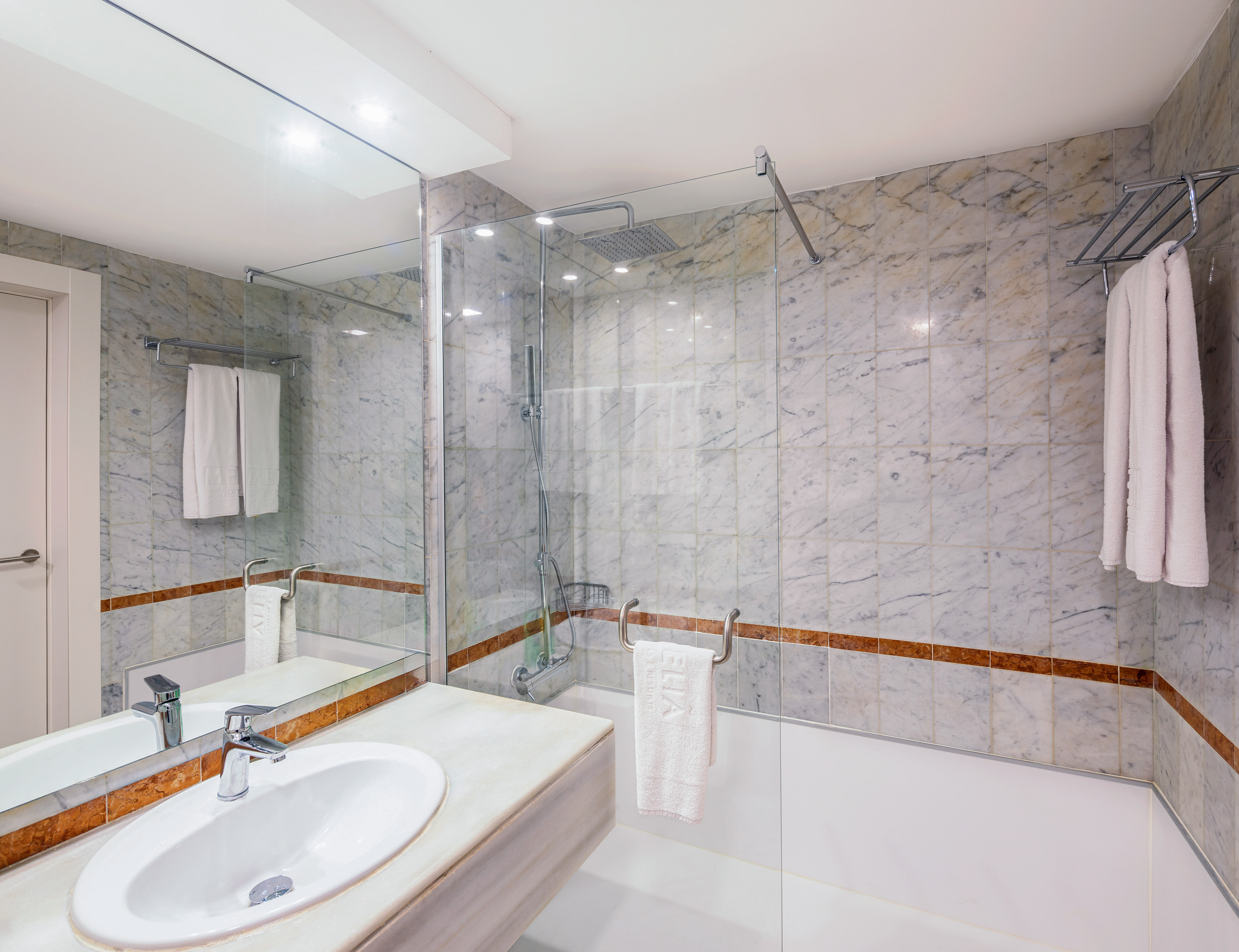 a bathroom with marble walls and a sink