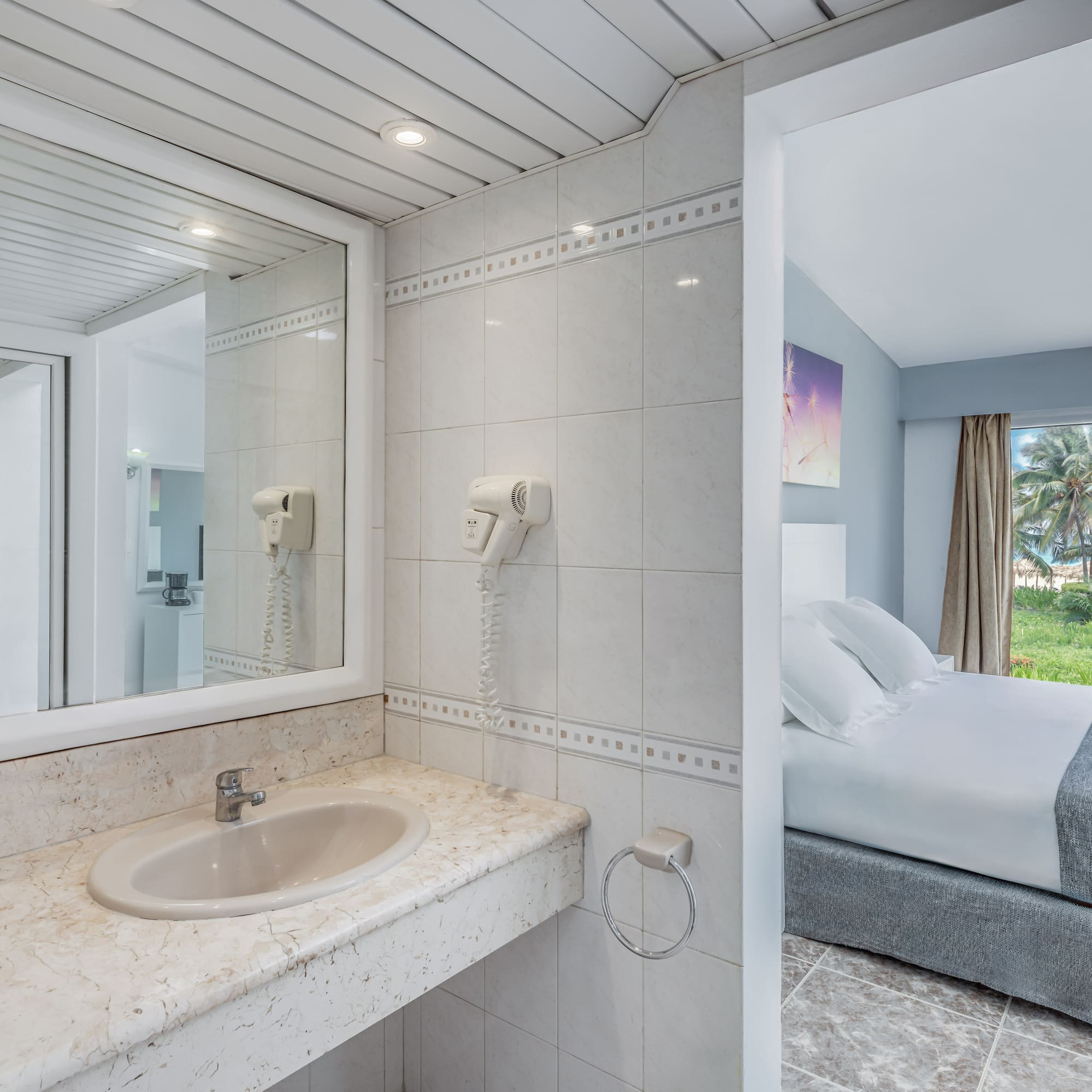 a bathroom with a bed and a mirror