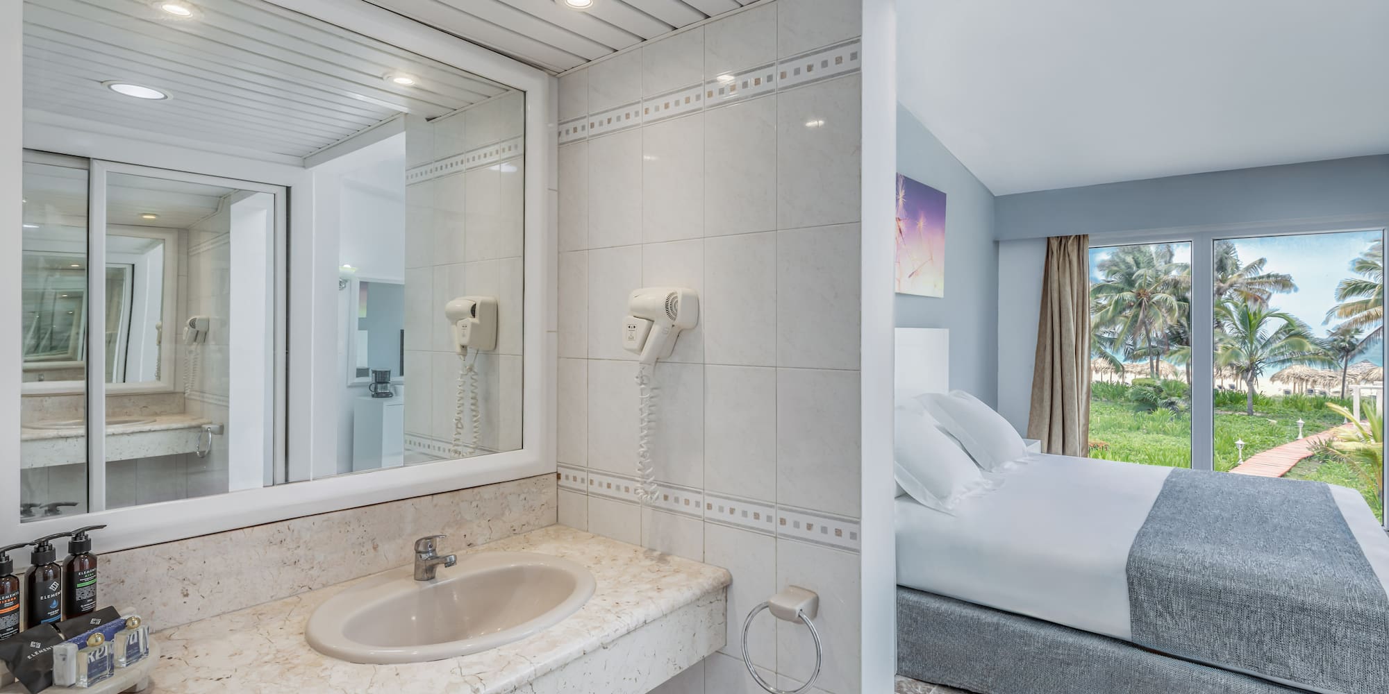 a bathroom with a bed and a mirror