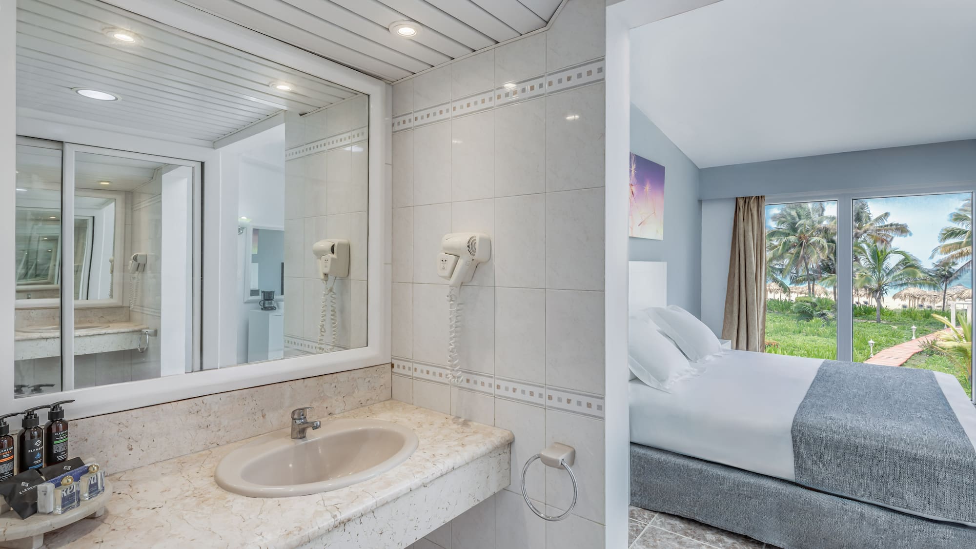 a bathroom with a bed and a mirror