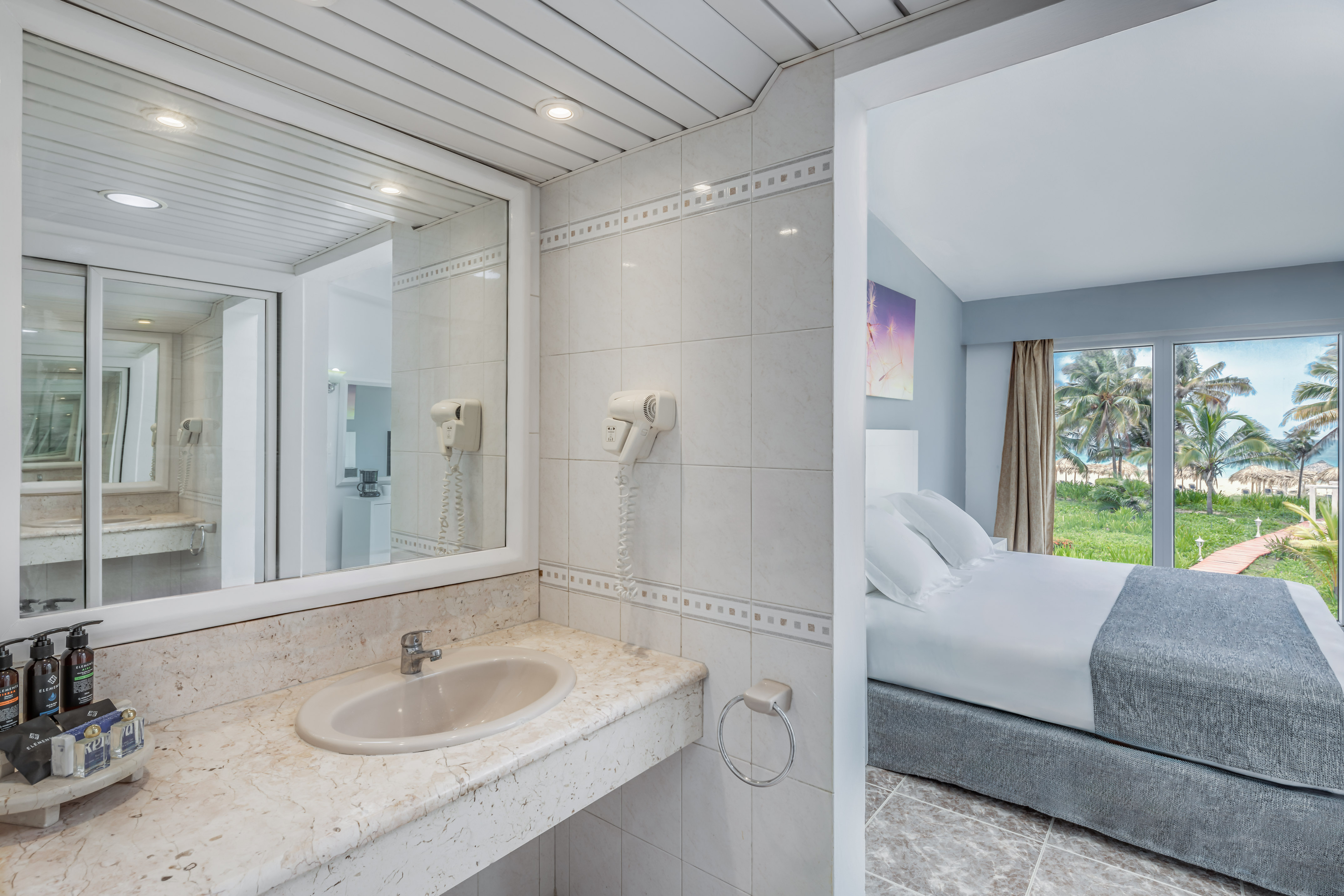 a bathroom with a bed and a mirror