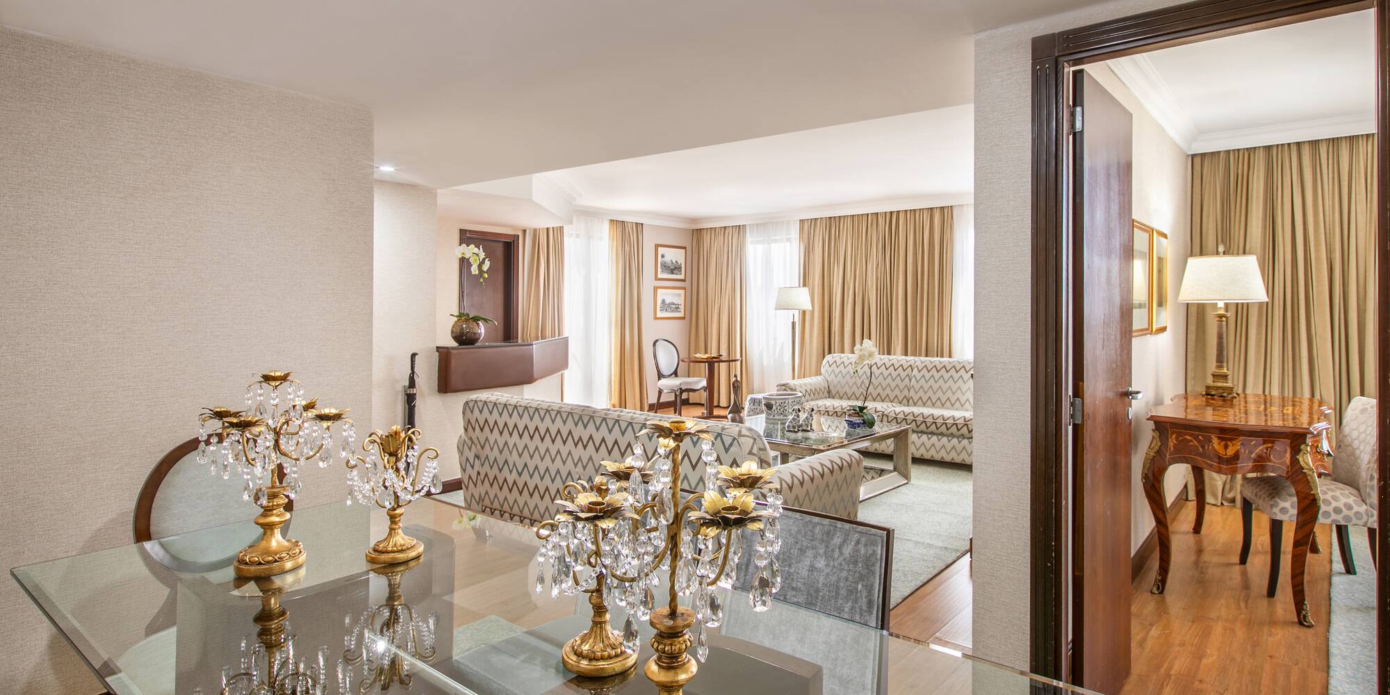 a room with a glass table and a couch