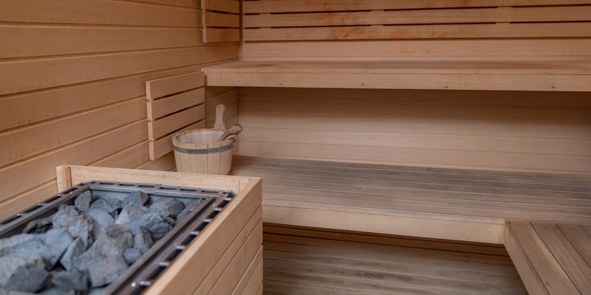 a sauna with a bucket of rocks