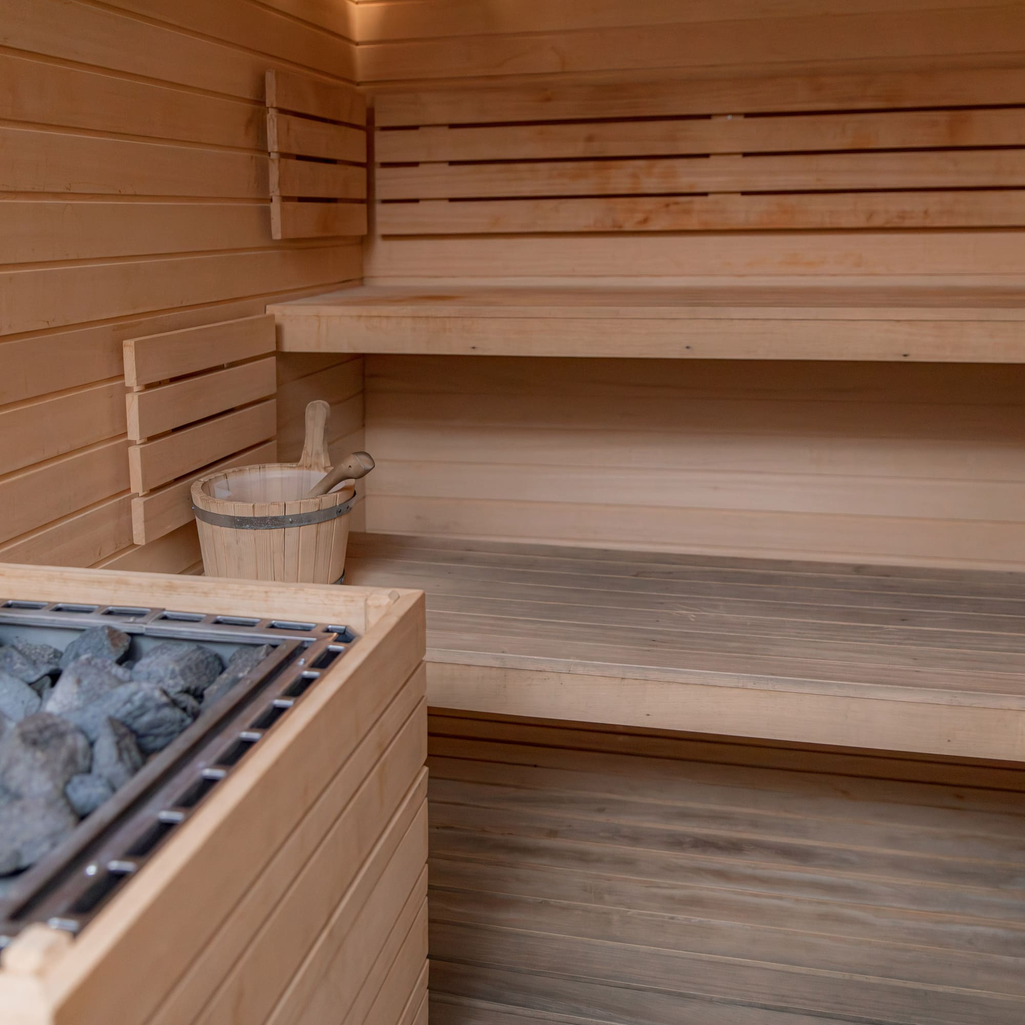 a sauna with a bucket of rocks