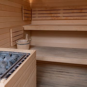 a sauna with a bucket of rocks