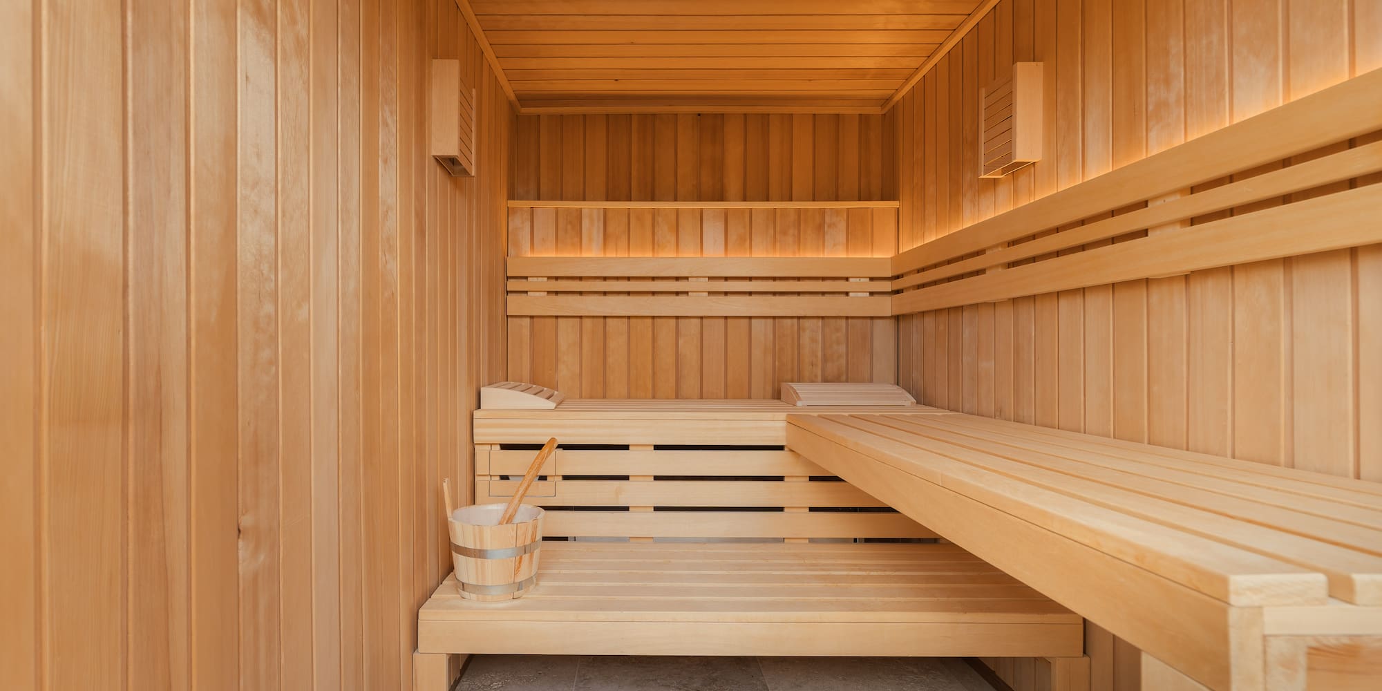 a wooden sauna with a bucket and bucket