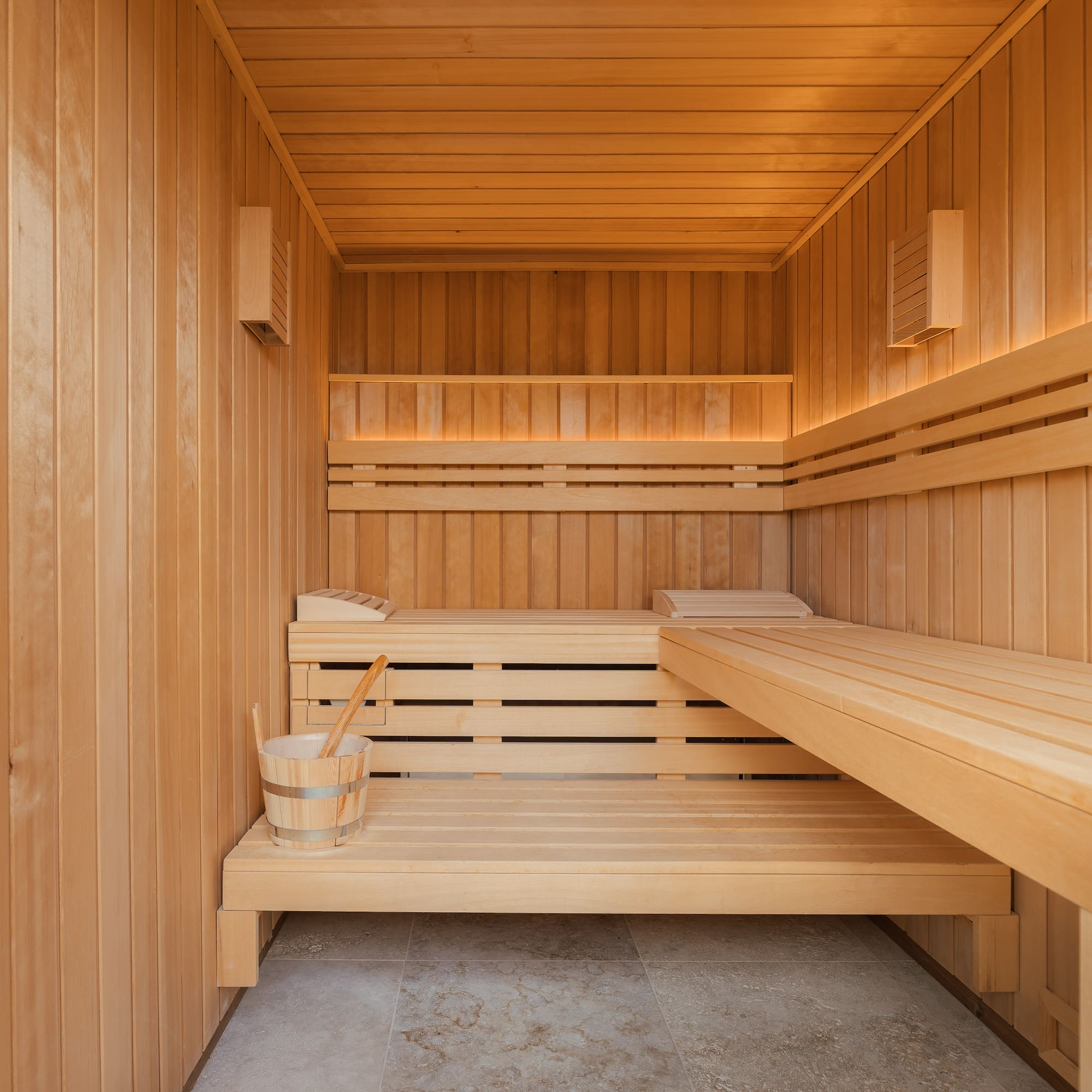 a wooden sauna with a bucket and bucket
