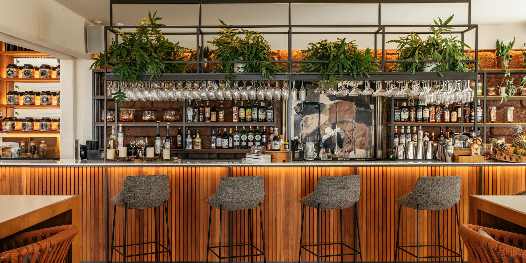 a bar with a shelf and glasses on top