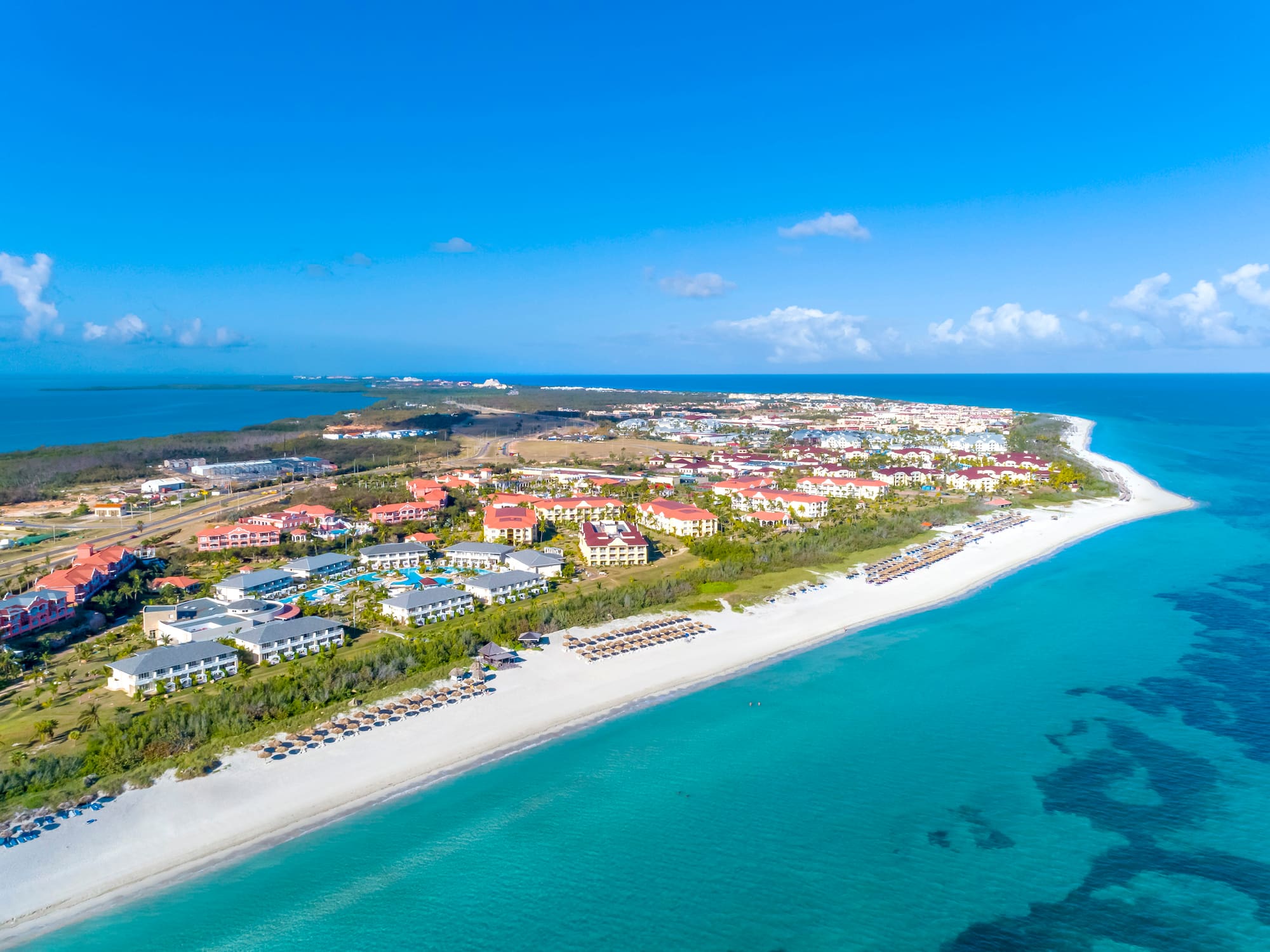 a beach with buildings and a body of water