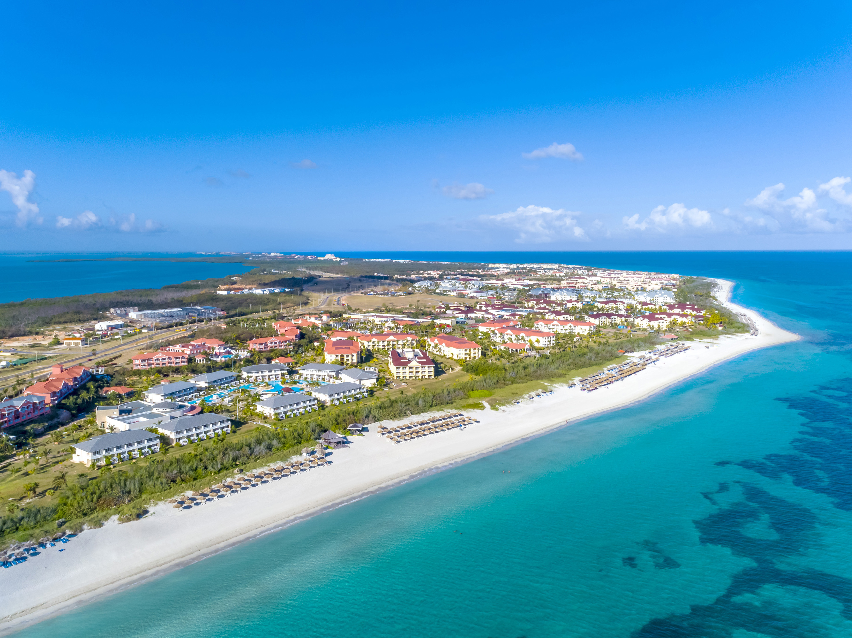 a beach with buildings and a body of water