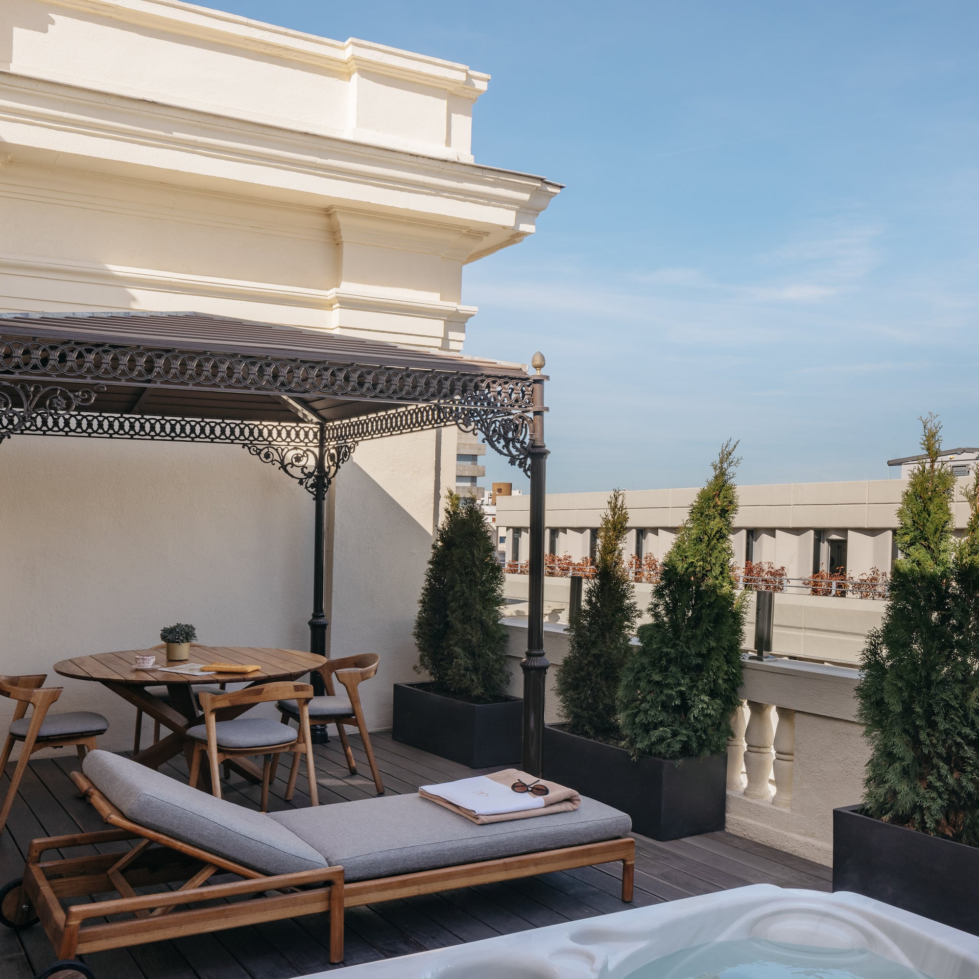 a patio with a hot tub and a table