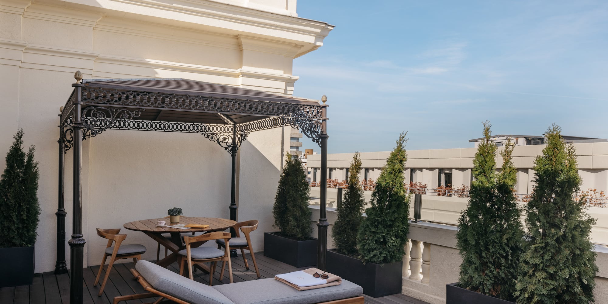 a patio with a hot tub and a table