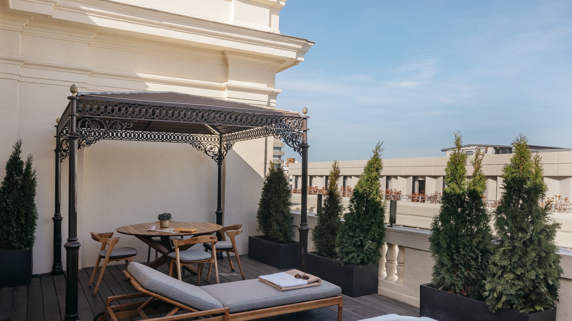 a patio with a hot tub and a table