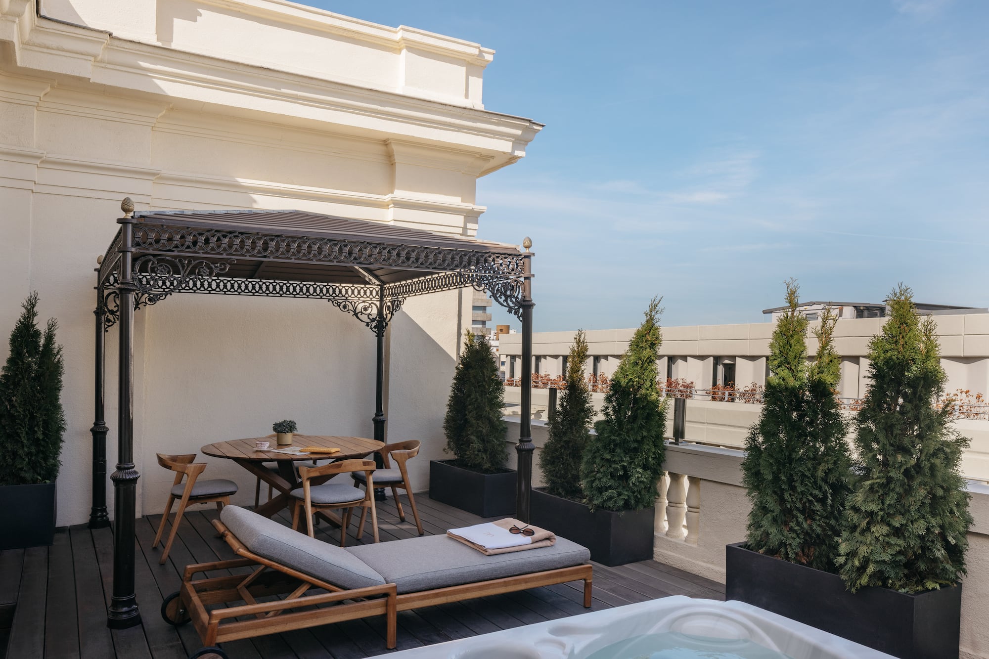a patio with a hot tub and a table