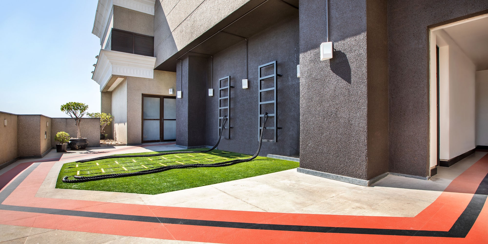 a building with a lawn and a hose attached to it