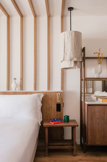 a bed with a shelf and books on it