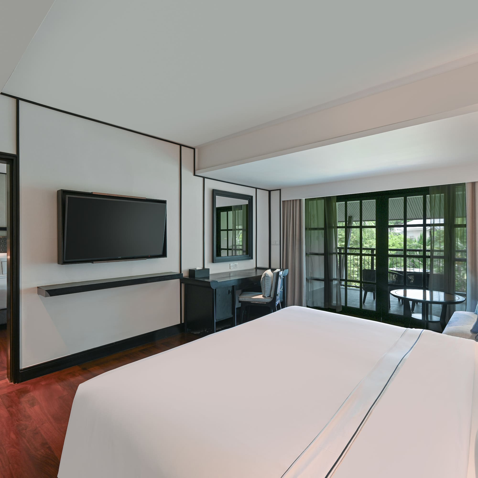 a room with a bed and a television