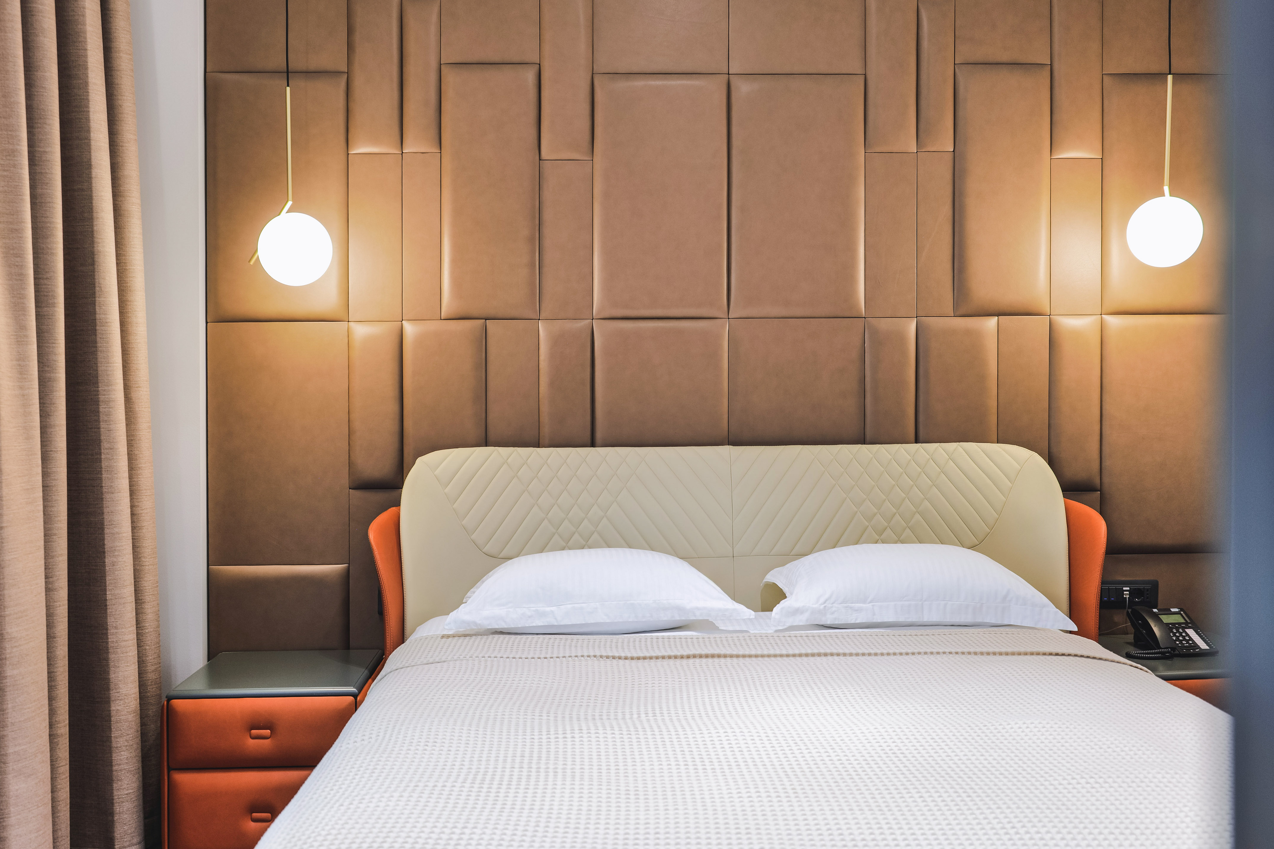 a bed with a light on the wall