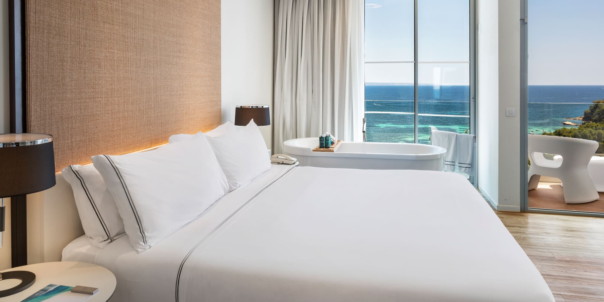 a bed with a bathtub and a tub in a hotel room