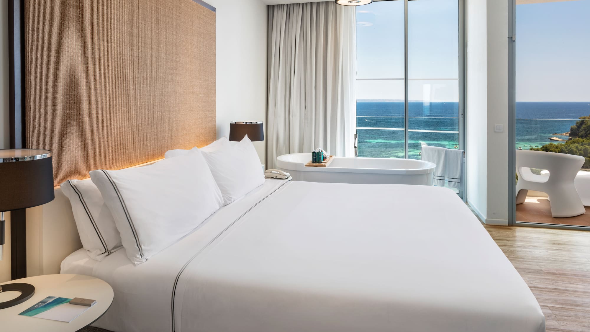 a bed with a bathtub and a tub in a hotel room