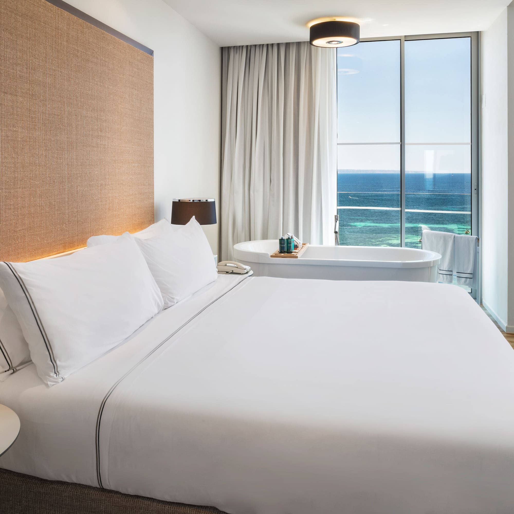 a bed with a bathtub and a tub in a hotel room