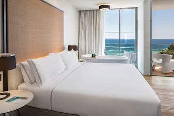 a bed with a bathtub and a tub in a hotel room