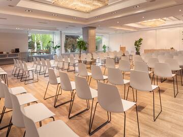 a room with many white chairs