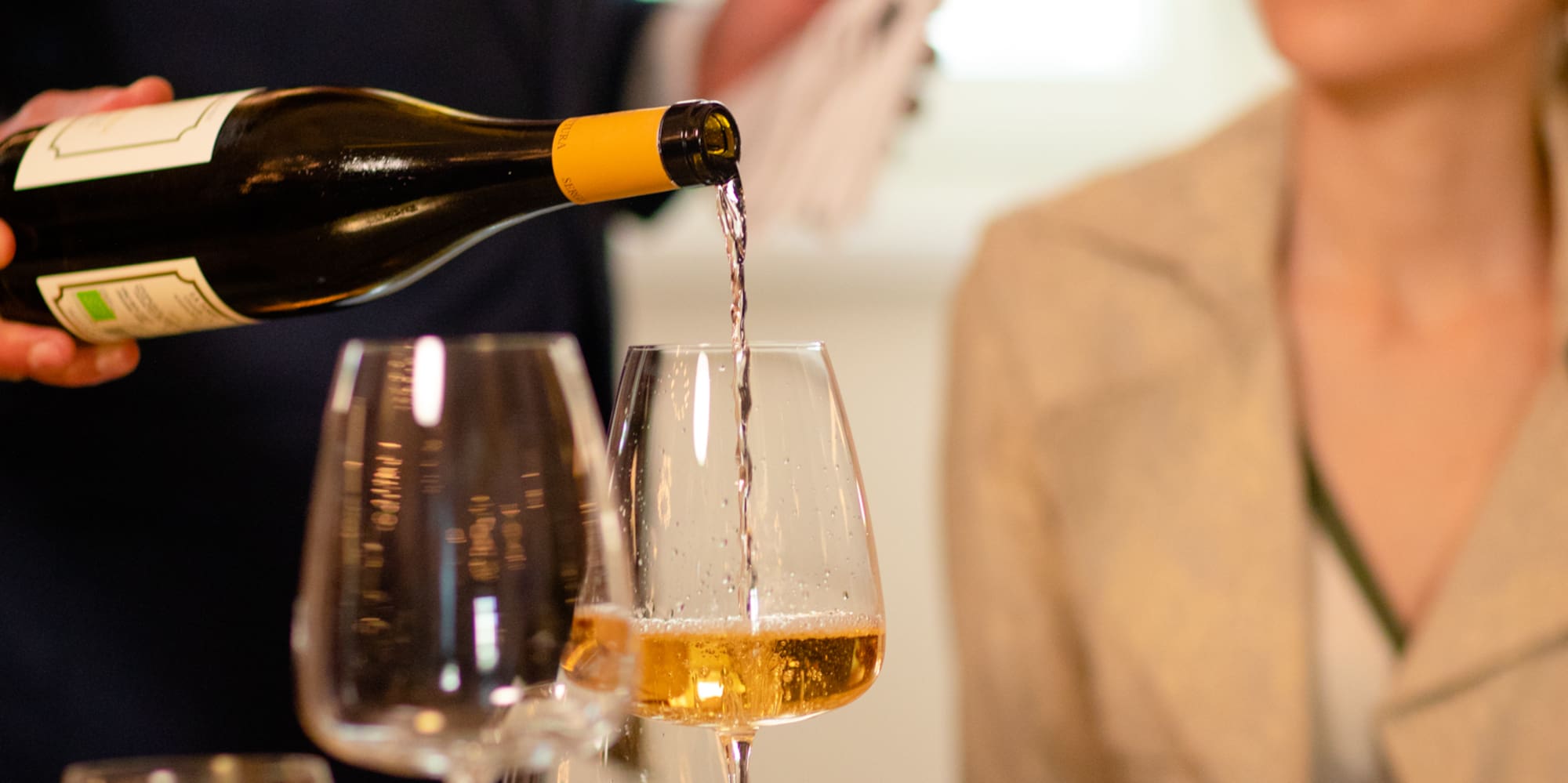 a man pouring wine into a glass