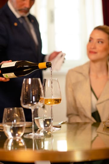 a man pouring wine into a glass