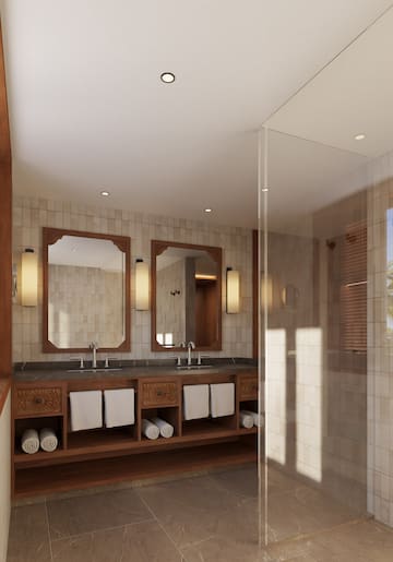 a bathroom with a shower and a double sink