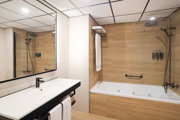 a bathroom with a bathtub and shower