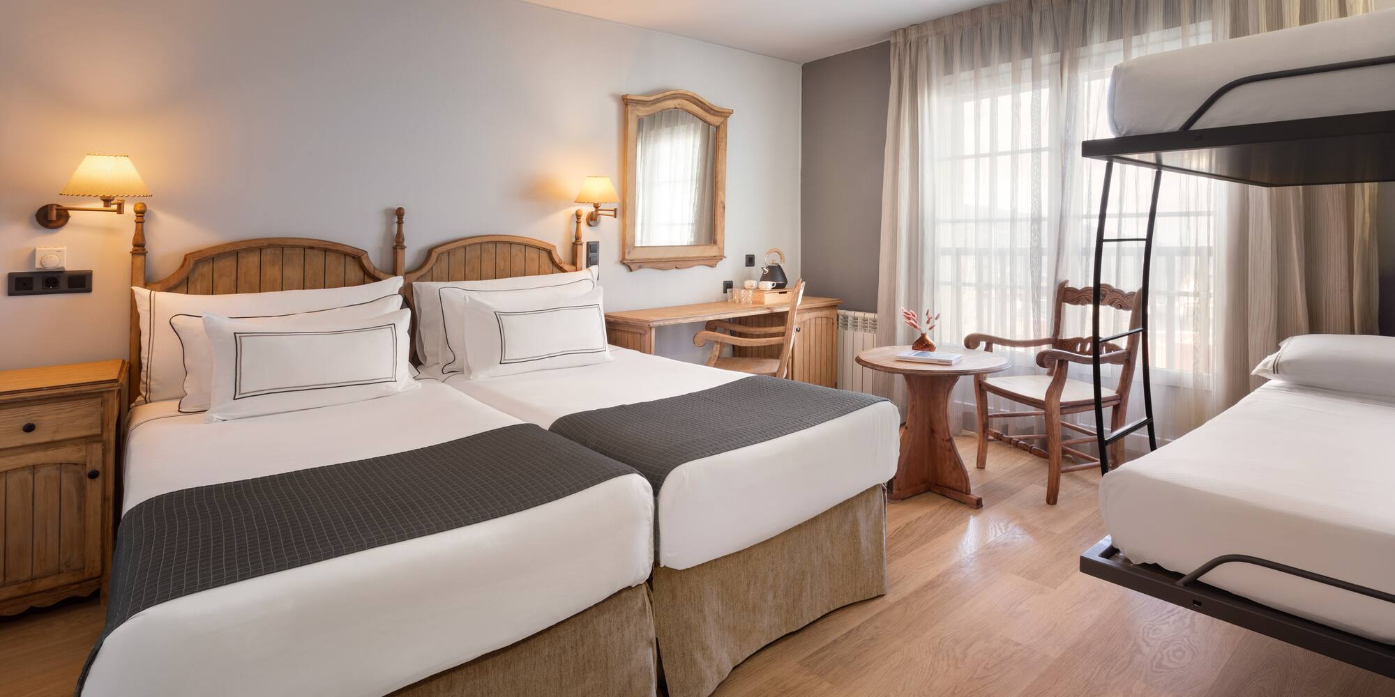 a room with two beds and a table