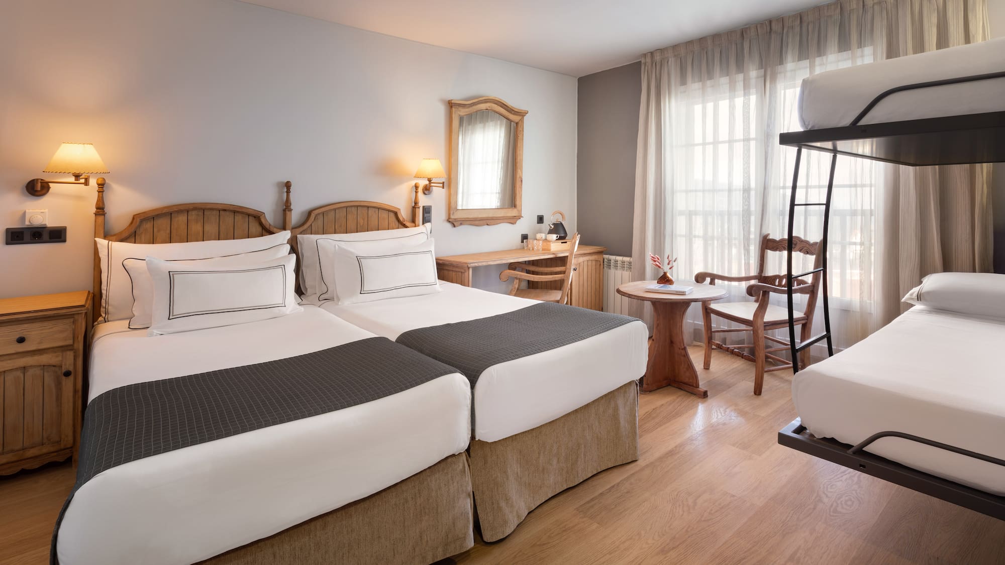 a room with two beds and a table