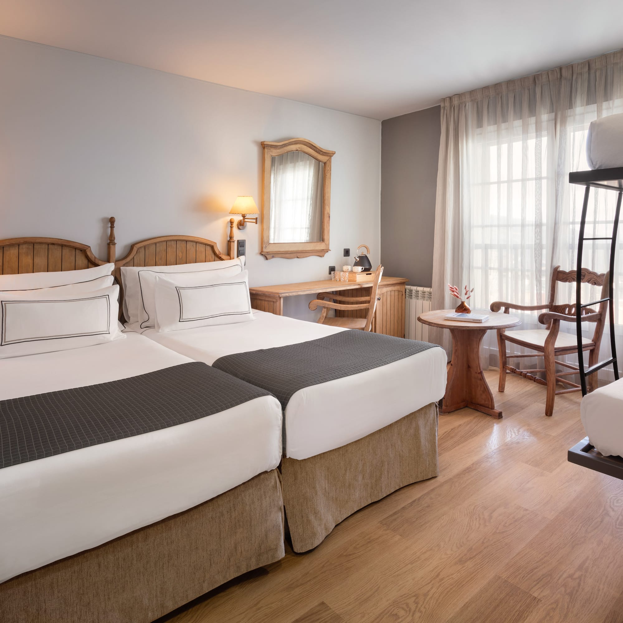 a room with two beds and a table