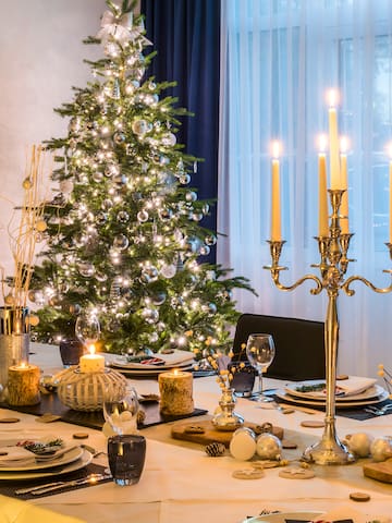 a christmas tree with candles on a table