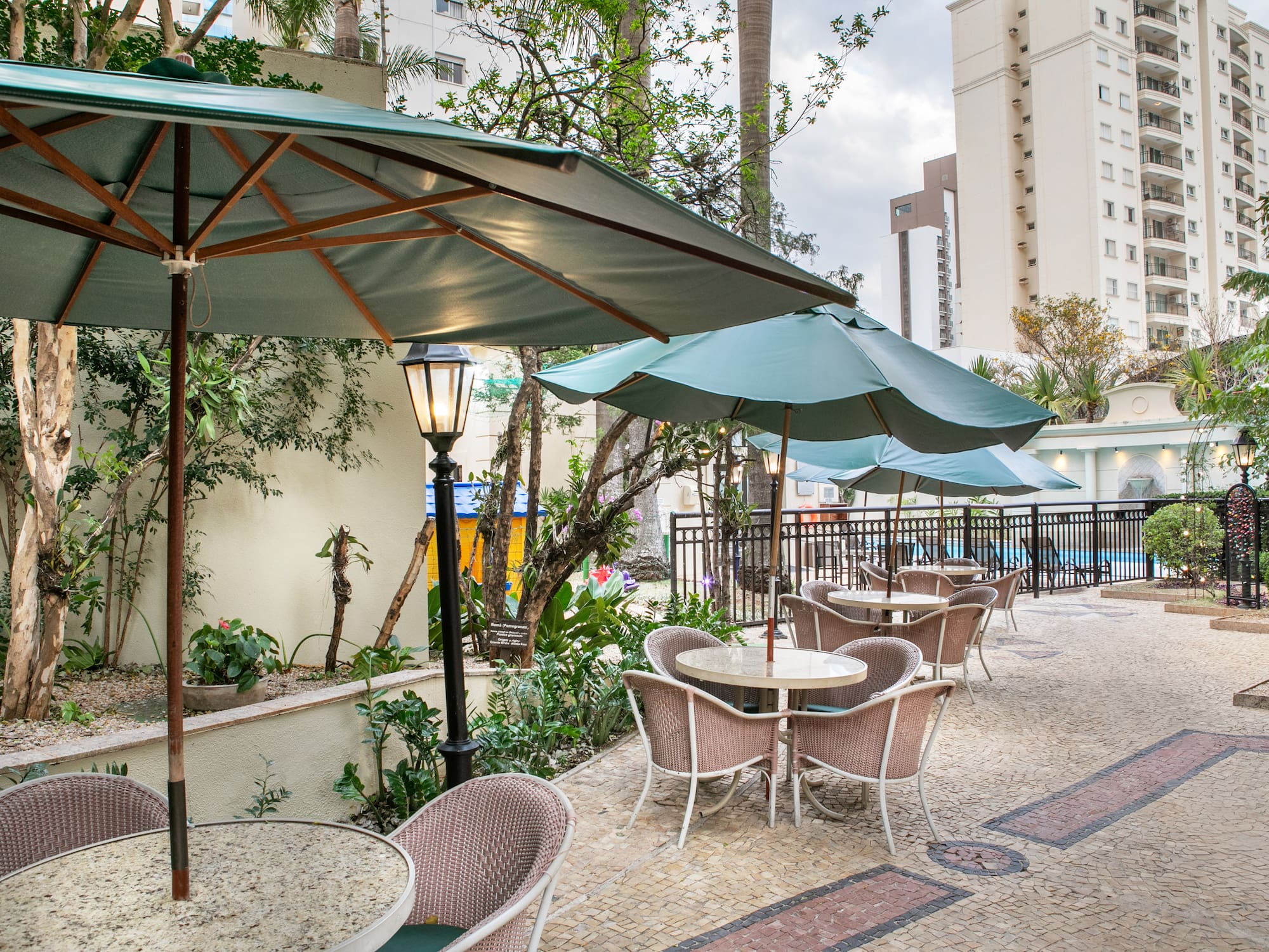 a patio with tables and umbrellas