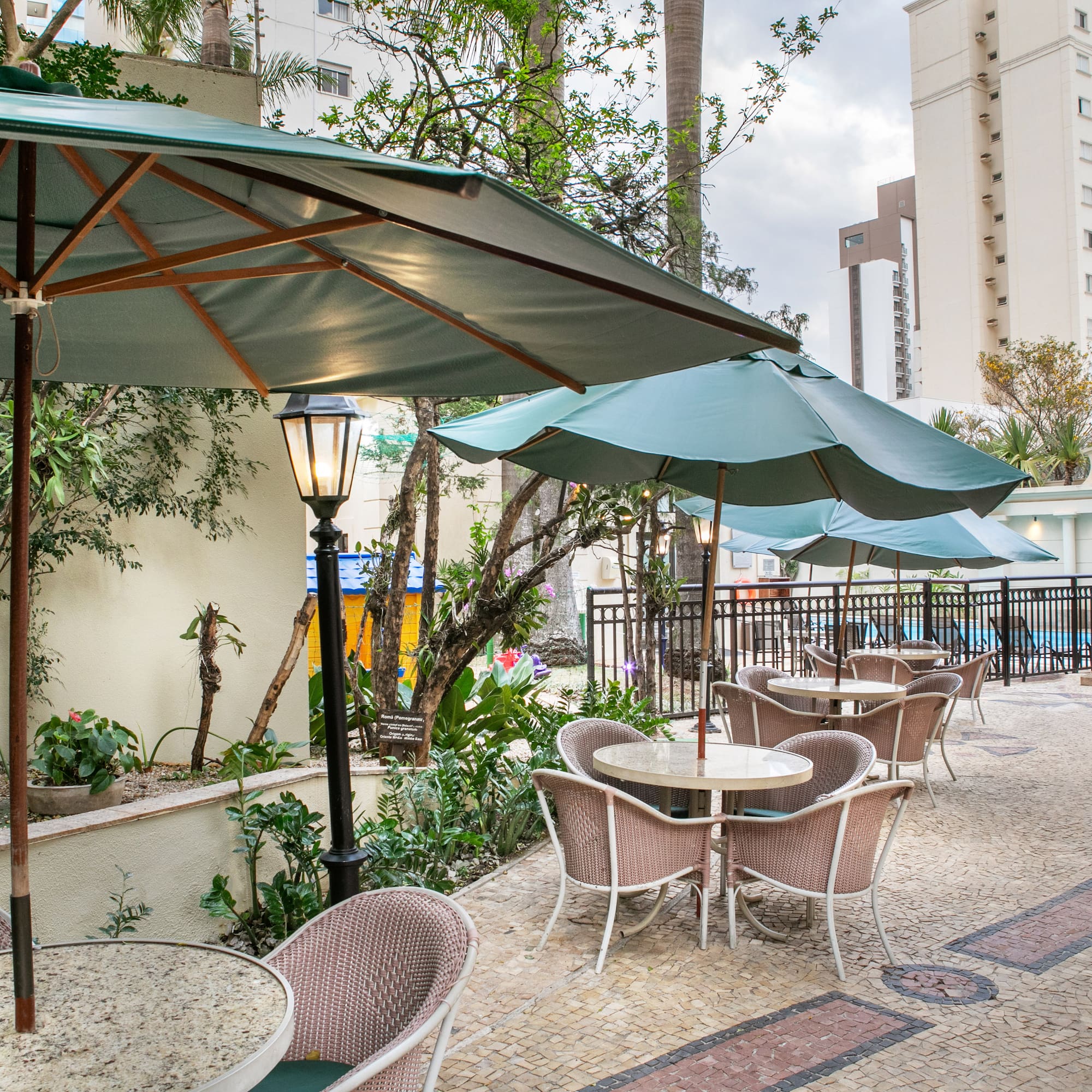 a patio with tables and umbrellas