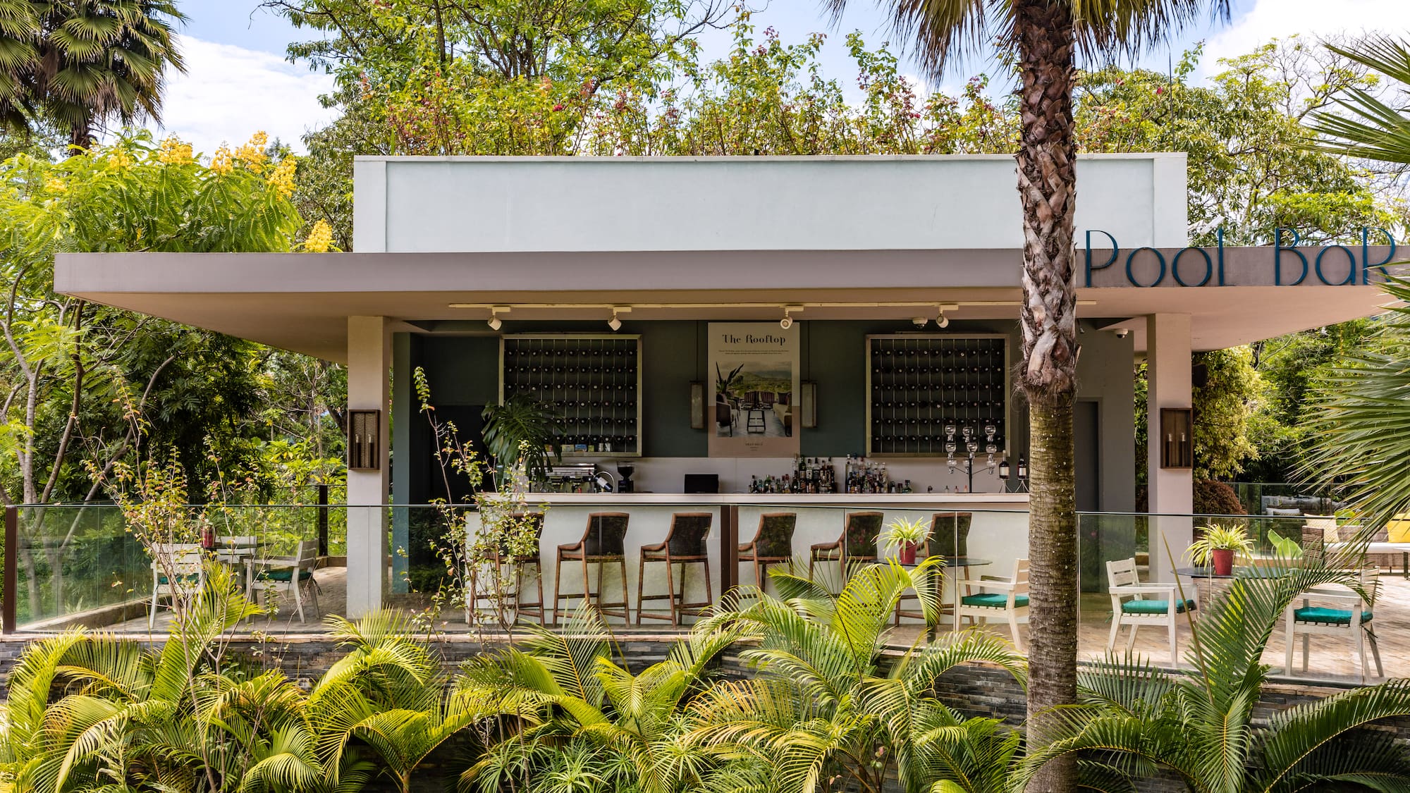 a building with a bar and chairs and trees