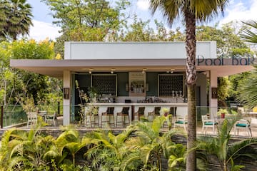 a building with a bar and chairs and trees